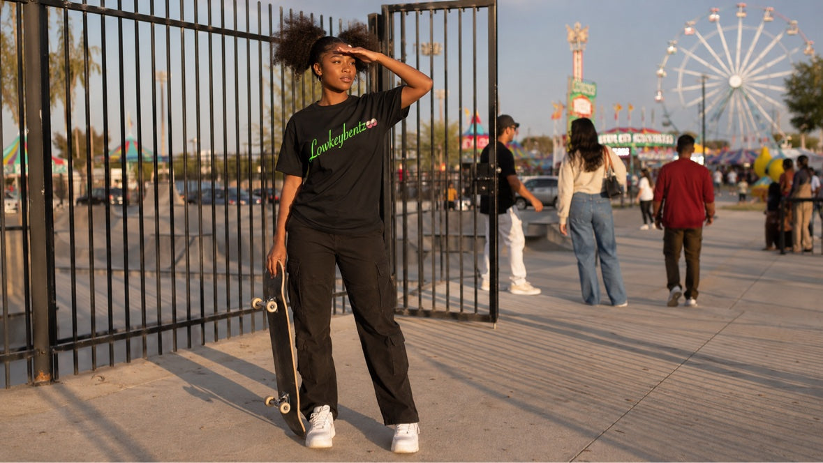 GETTY GREEN worn by model with skateboard at fair gate